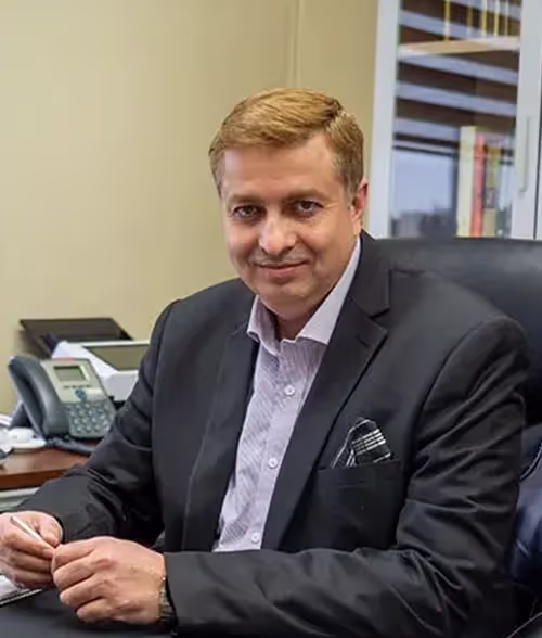 Sohail Afzal, CEO and Founder of GTA Accounting Group, seated at desk in professional attire, emphasizing leadership in accounting services for businesses in San Francisco.